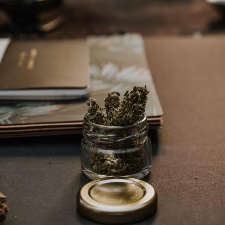 Close-Up Photo of Kush On Glass Container